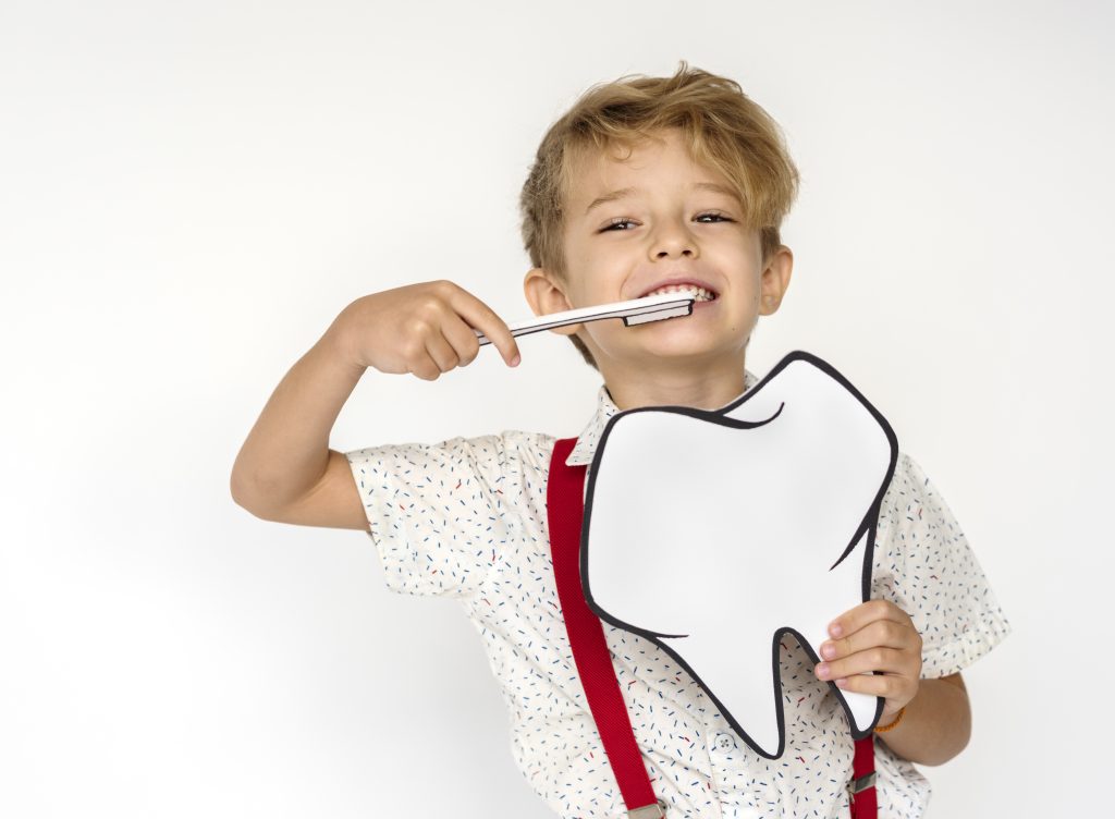 Teaching Kids to Brush Can Be Fun and Effective 3 kid portrait holding paper icon